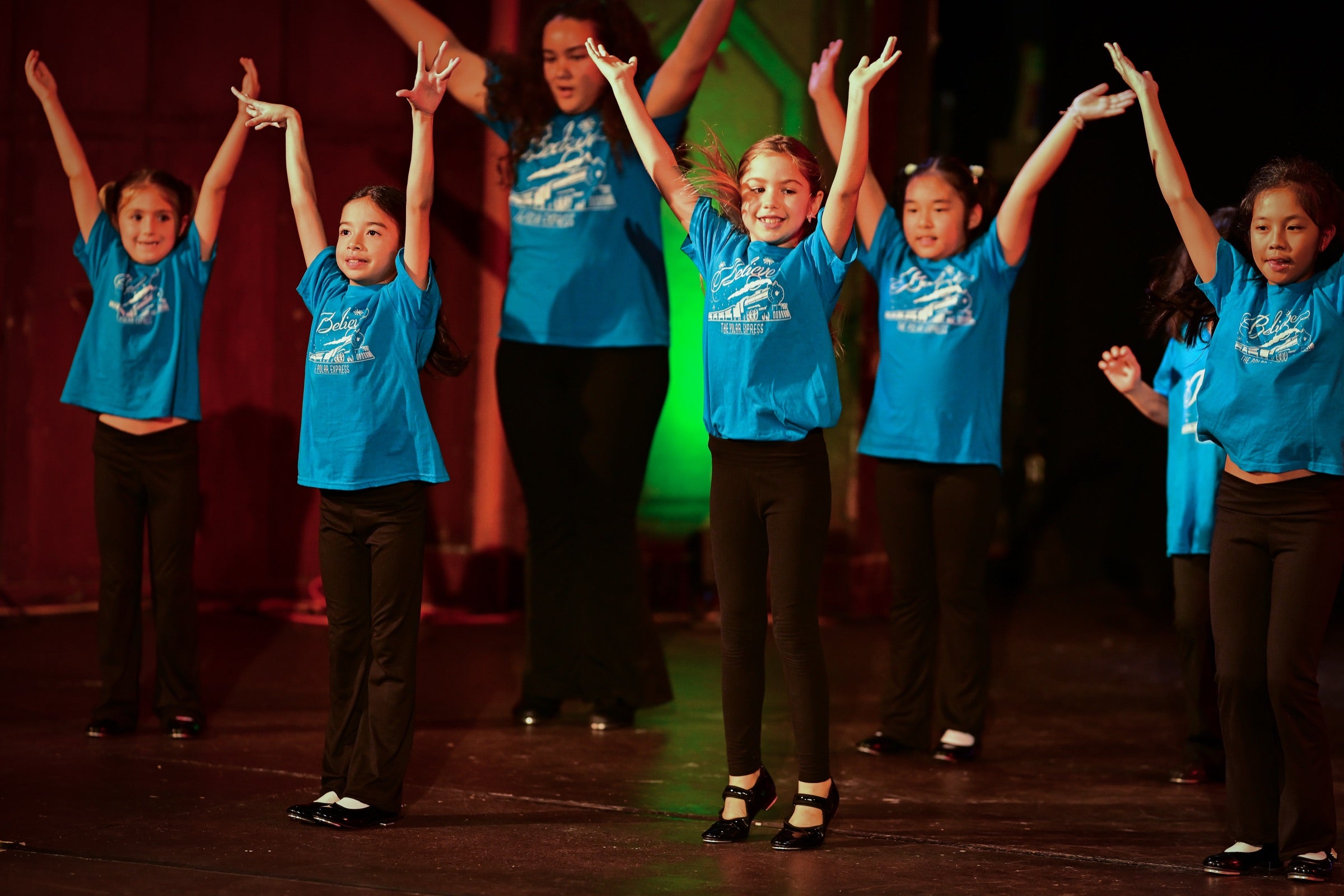 Keiki hip hop dancers performing energetically on stage