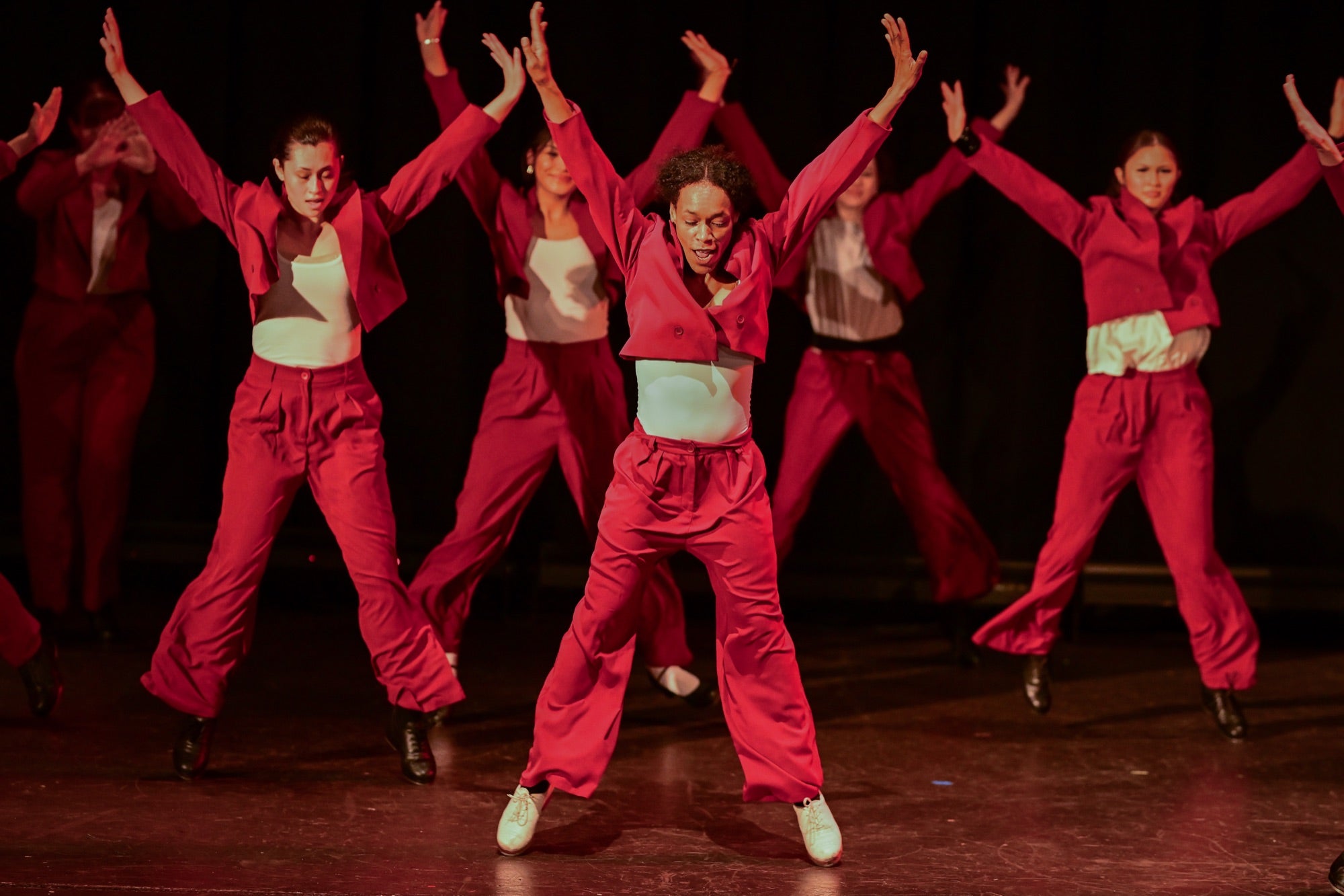 Teen dancers in red performing synchronized hip hop